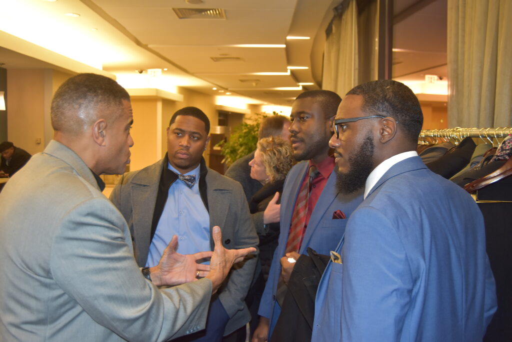 Men in suits conversing at a formal event