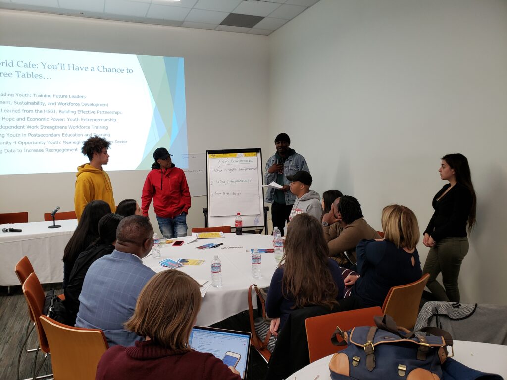 Workshop participants around table with presenter