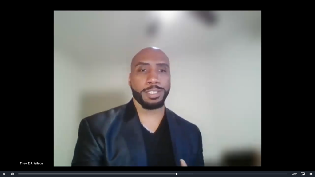Man in blazer smiling during video call