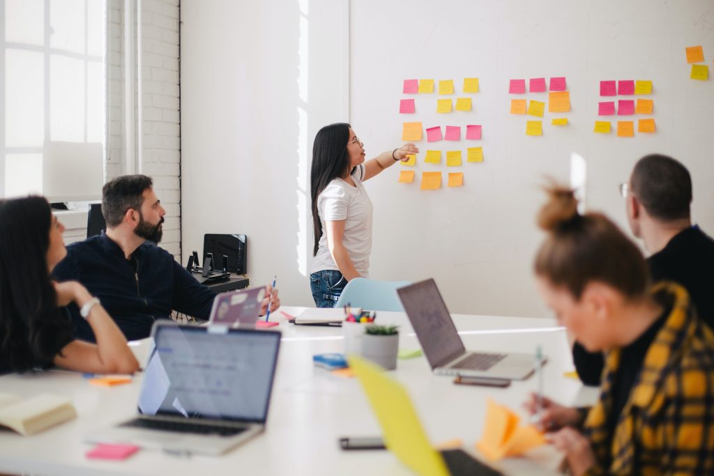 Team brainstorming with sticky notes on wall