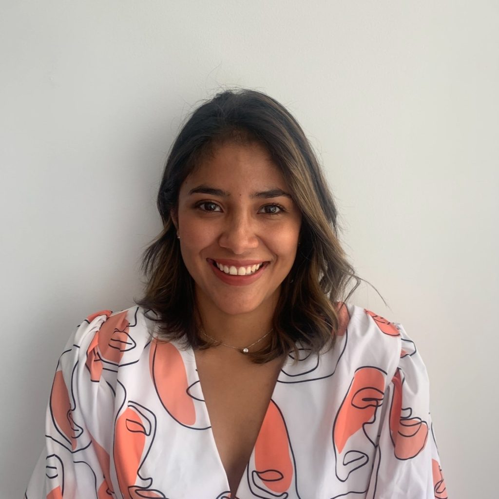 Smiling woman wearing abstract-patterned blouse