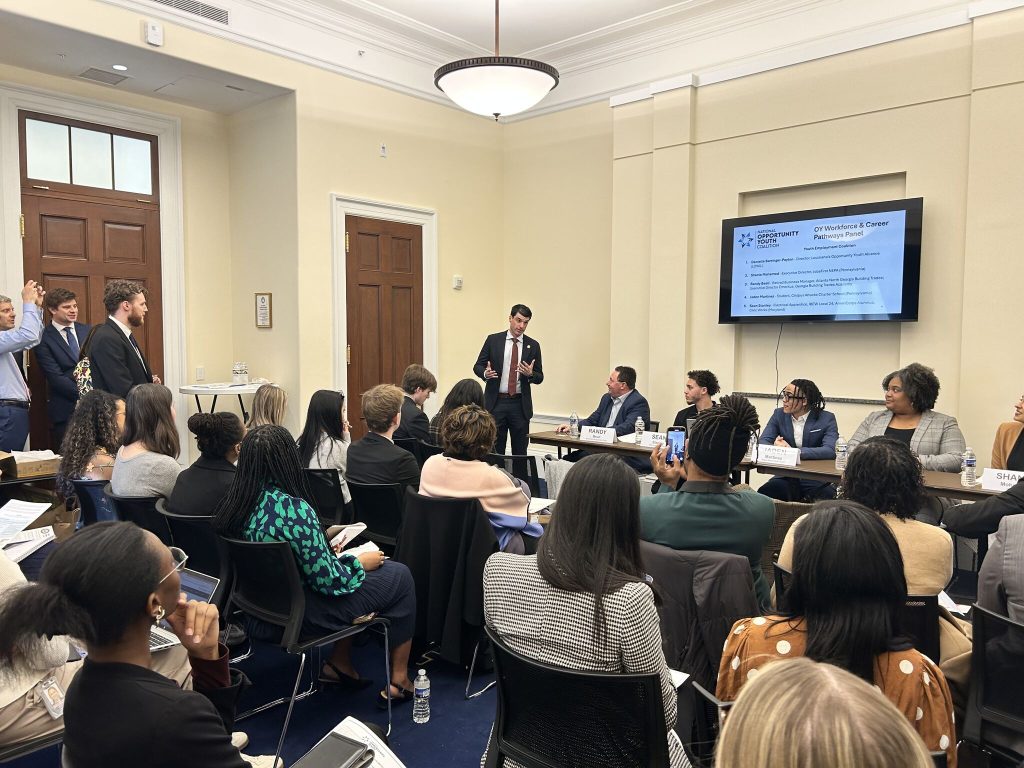 Panel discussion in conference room with audience