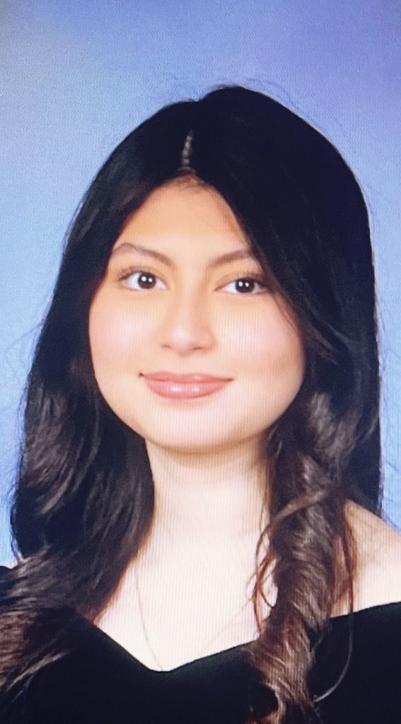 Smiling young woman with long dark hair