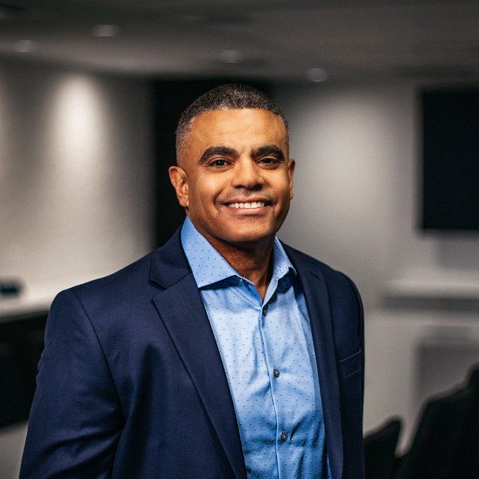 Smiling man in blue shirt and blazer