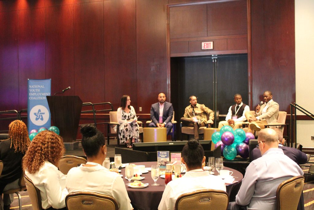Panel discussion at conference with seated audience