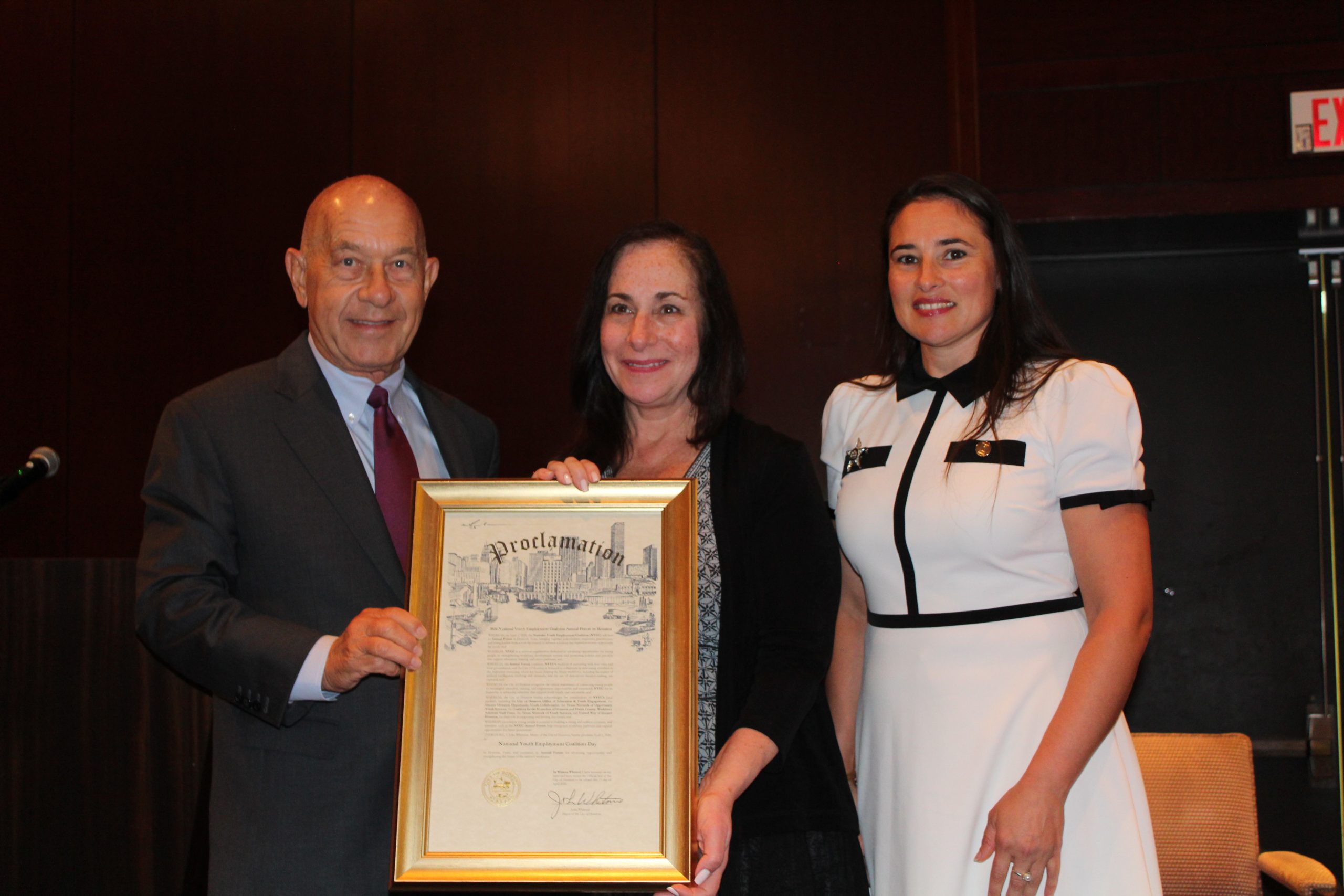 Mayor Whitmire presents the official proclamation to NYEC Executive Director Dr. Mimi Haley
