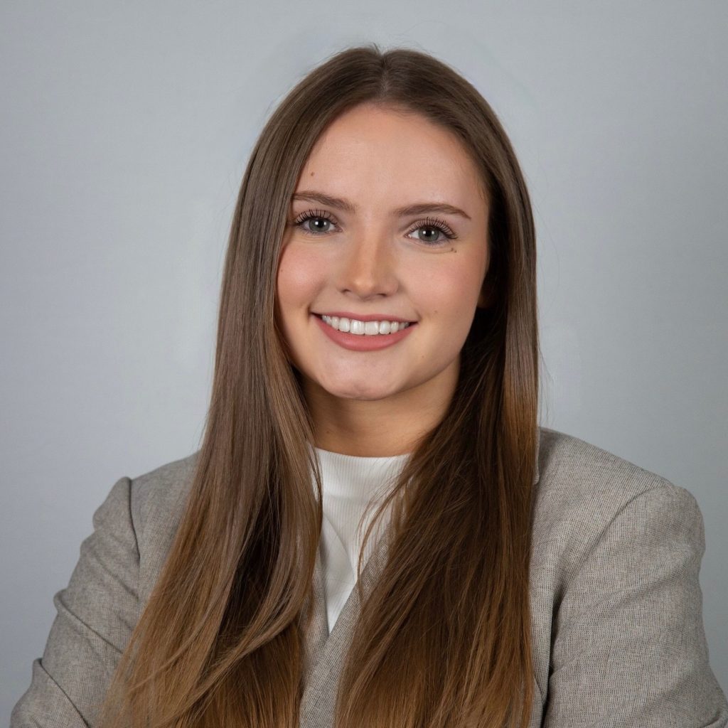 Smiling professional woman in gray blazer