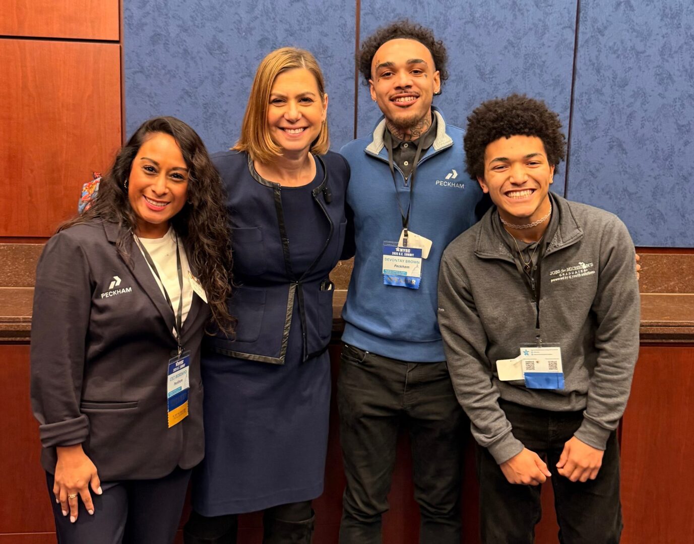 Four DC Summit attendees smiling with their arms around each other