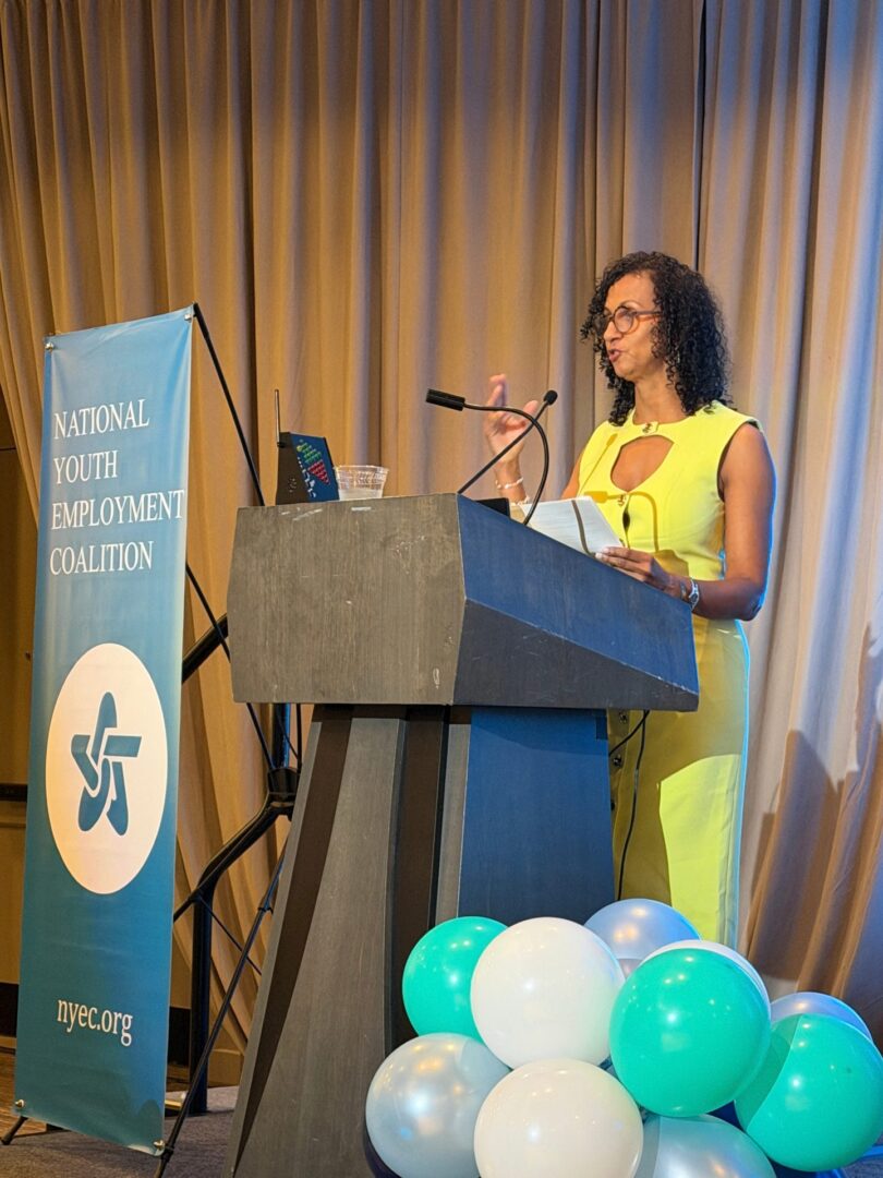 A speaker addresses attendees from the podium at NYEC's 2026 DC Summit