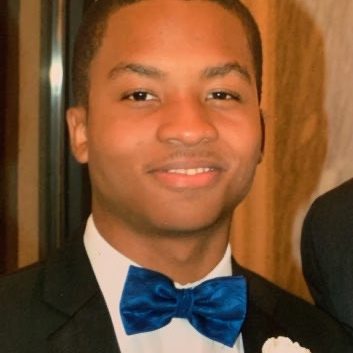 Smiling man in tuxedo with blue bow tie