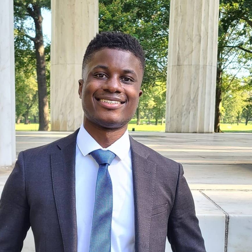 Smiling professional in suit at marble columns