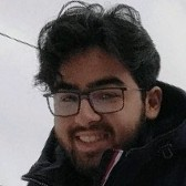 Smiling person wearing glasses outdoors
